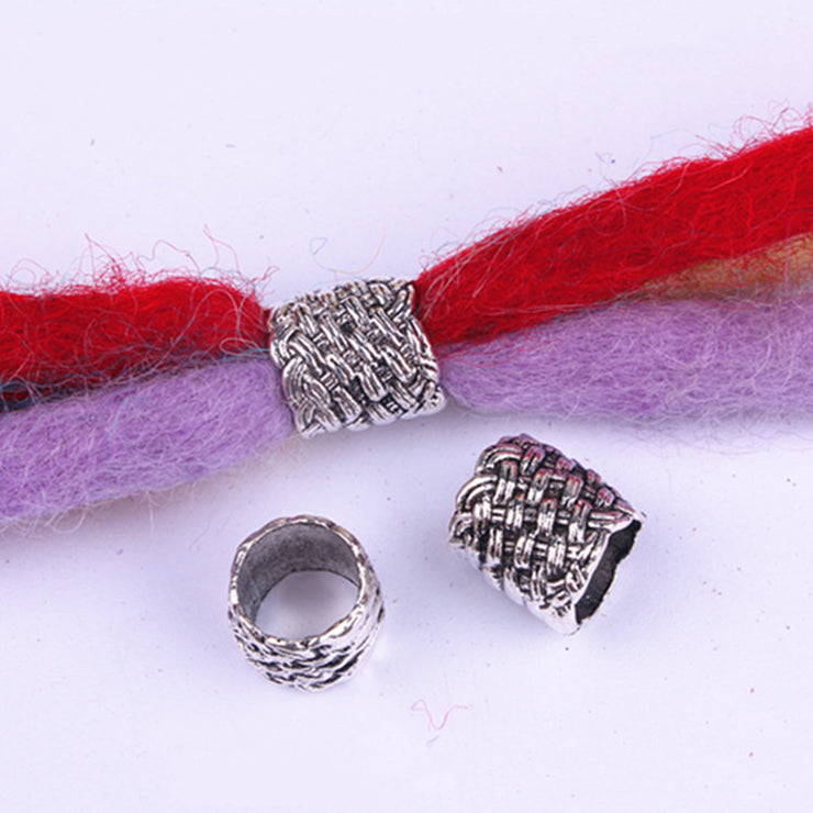 Silver beads on a red and purple fabric background