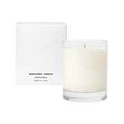 Sandalwood + Tobacco scented candle with packaging on a white background